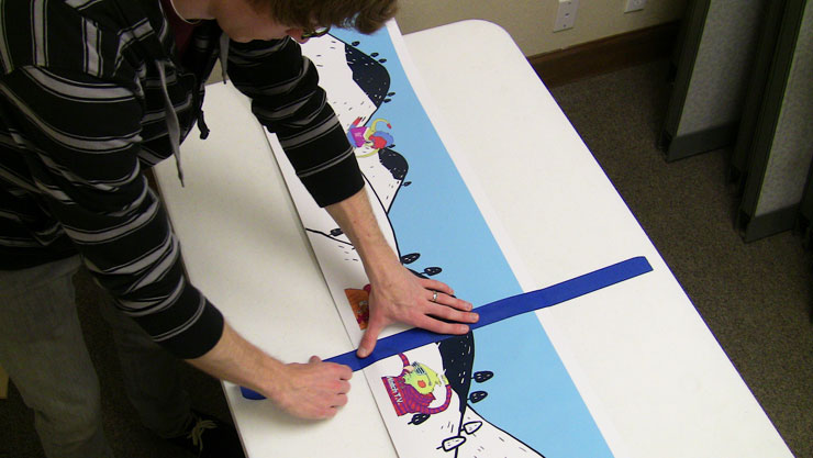 Applying vinyl board wrap to a Blank Snowboard
